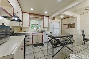Mesa apartment for rent - A kitchen with white cabinets and a black stove top oven.