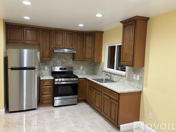 Watsonville house for rent - A kitchen with a refrigerator, oven, and sink.