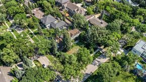 Winnipeg house for rent - A bird's eye view of a residential area with houses and trees.