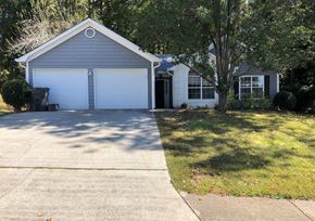 Lawrenceville house for rent - A two-car garage with a white door and a black door.