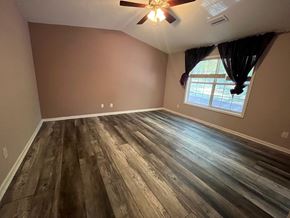 Lawrenceville house for rent - A room with wooden flooring and a ceiling fan.