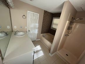 Lawrenceville house for rent - A bathroom with a white door and a shower.