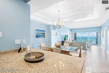 Melbourne Beach apartment for rent - A spacious living room with a large glass table and a chandelier.