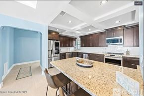 Melbourne Beach apartment for rent - A kitchen with a table and chairs in the middle of it.