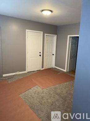 Brockton apartment for rent - A room with two white doors and a carpeted floor.