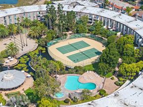San Diego apartment for rent - A large outdoor tennis court is surrounded by trees and buildings.