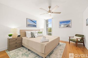 San Diego apartment for rent - A bedroom with a bed, chair, and two pictures on the wall.