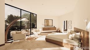 Winter Park apartment for rent - A modern bedroom with a large bed and a chair by the window.