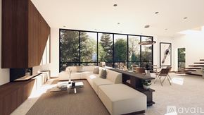 Winter Park apartment for rent - A modern living room with a large window overlooking a forest.