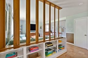 Richmond house for rent - A room with a bookshelf and a mirror on the wall.
