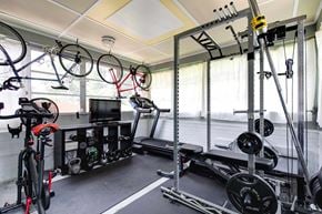 Richmond house for rent - A home gym with a treadmill, weights, and exercise bikes.