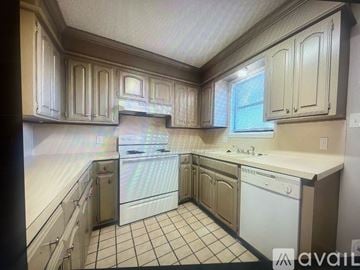 Texarkana apartment for rent - A kitchen with white appliances and cabinets.