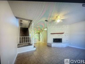 Texarkana apartment for rent - A living room with a fireplace and a staircase.