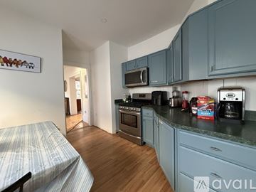 Boston apartment for rent - A kitchen with wooden cabinets and a granite countertop.
