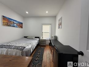 Boston apartment for rent - A bedroom with two beds and a desk.
