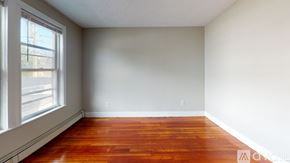 Somerville apartment for rent - A room with wooden floors and a window.