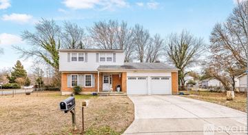 Dover house for rent - A two-story house with a garage and a driveway.