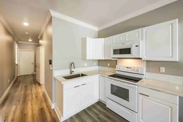Kapolei apartment for rent - A modern kitchen with white appliances and cabinets.