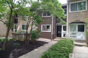 Rockville apartment for rent - A tree in a front yard of a brick building.