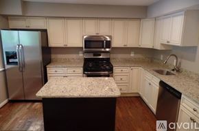 Rockville apartment for rent - A kitchen with a granite countertop and stainless steel appliances.
