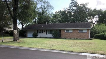 Dayton house for rent - A modern kitchen with a stove top oven and a microwave above it.