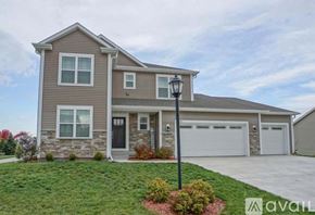 Oconomowoc house for rent - A house with a grey roof and a white garage door.