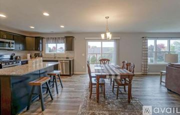 Oconomowoc house for rent - A kitchen with a dining table and chairs.