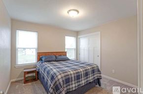 Oconomowoc house for rent - A bedroom with a bed, nightstand, and window.