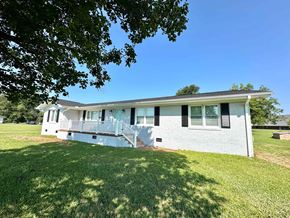 Taylors house for rent - A house with a white exterior and a green lawn.