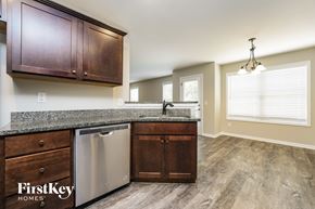 Jefferson house for rent - A kitchen with wooden cabinets and a stainless steel dishwasher.