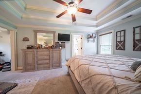 Midland house for rent - A bedroom with a large bed and a ceiling fan.