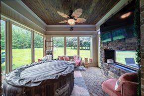 Midland house for rent - A room with a hot tub and a fireplace.