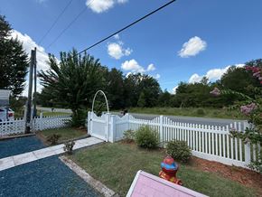 Interlachen house for rent - A white picket fence surrounds a pool with a slide.