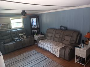 Interlachen house for rent - A living room with a grey couch and a white sofa bed.
