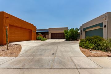 Tucson house for rent - A modern house with a driveway and garage doors.