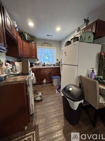Oak Ridge house for rent - A kitchen with a white fridge and wooden cabinets.