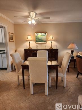 Naples condo for rent - A dining room with a table set for four.