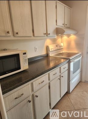 Naples condo for rent - A swimming pool surrounded by palm trees.