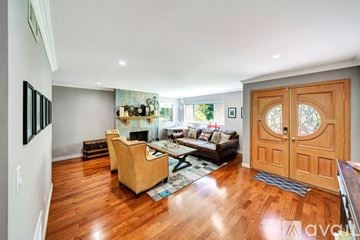 Los Angeles house for rent - A living room with a tan couch and a wooden floor.
