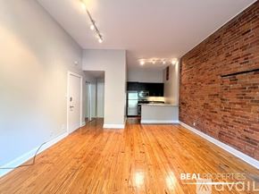 Chicago apartment for rent - A living room with a brick wall and a television.