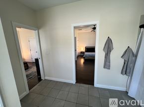 Terre Haute house for rent - A bedroom with a bed and a fan in the corner.