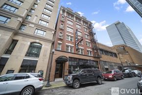 Portland apartment for rent - A street view of a building with cars parked in front.