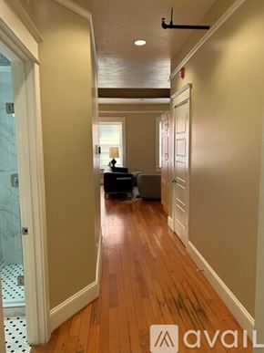 Portland apartment for rent - A hallway with a glass door and a tiled floor.