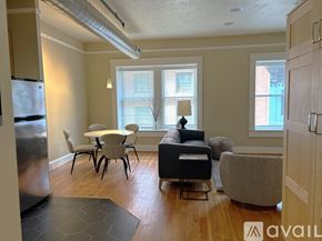 Portland apartment for rent - A spacious room with wooden floors and a large window.