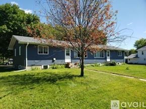 Cokato apartment for rent - A blue house with a tree in front of it.
