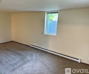 Cokato apartment for rent - A room with a window and a wall-mounted air conditioner.