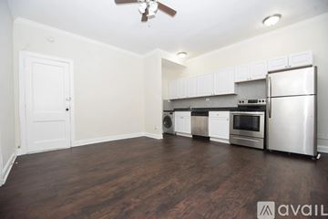 Chicago apartment for rent - A kitchen with white cabinets and a stainless steel refrigerator.