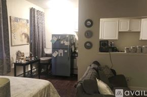 Chicago apartment for rent - A room with a ceiling fan and wooden flooring.