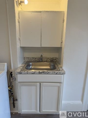 Portland house for rent - A kitchen with a sink and a cabinet.