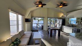 Big Pine Key house for rent - A living room with a couch, a table, and a ceiling fan.